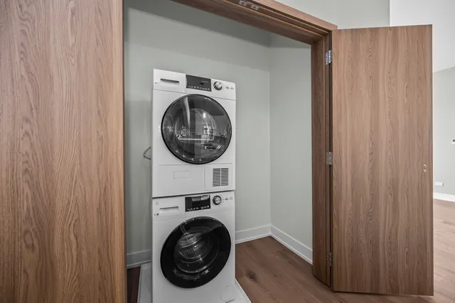 a view of a dining room with furniture a chandelier and wooden floor