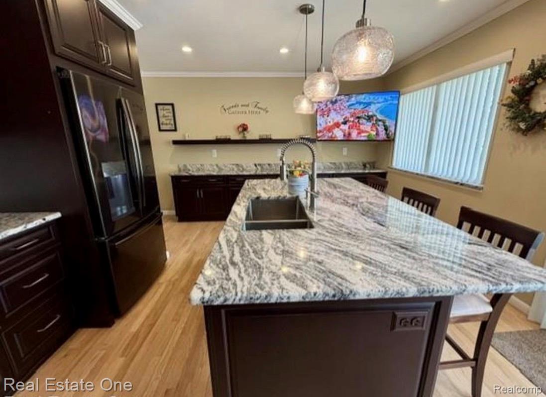 1115 Torpey Road Troy, MI 48083 - Photo 15 of 38 Expansive kitchen island featuring a rectangular undermount sink and a polished stone countertop
