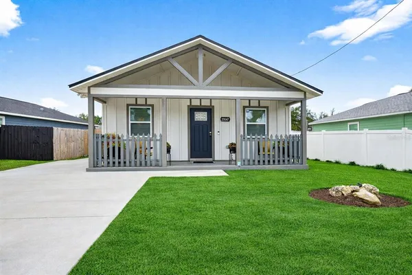 a view of a house with a yard and patio