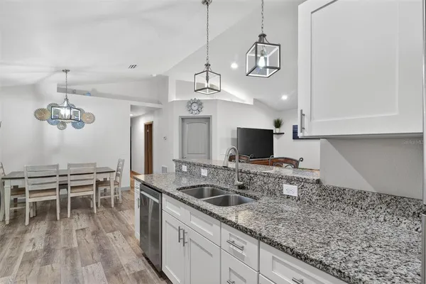 a kitchen with sink cabinets and wooden floor