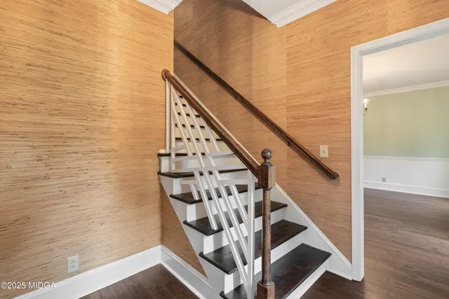 a kitchen with stainless steel appliances granite countertop a stove a refrigerator a kitchen island a dining table and chairs