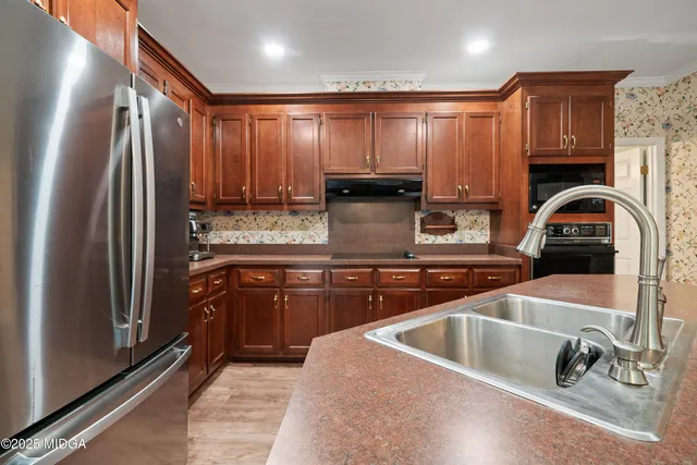 a bathroom with a tub a sink and a large mirror