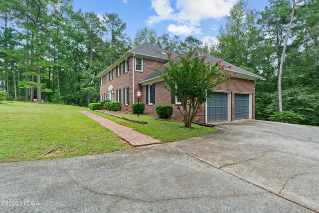 a view of a brick house with potted plants
