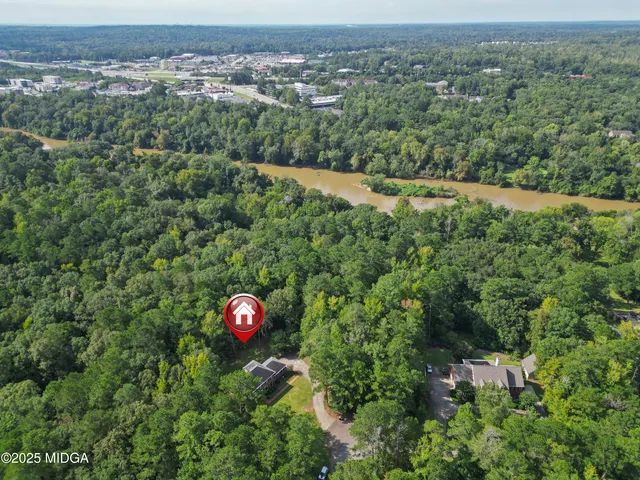 a living room with furniture floor to ceiling window and a table