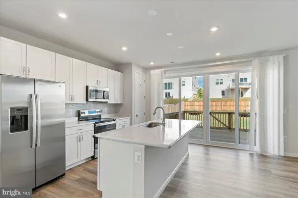 a kitchen with a sink and large window