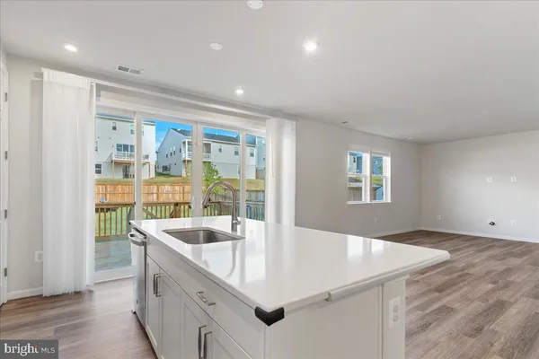 a kitchen with a refrigerator stove and white cabinets