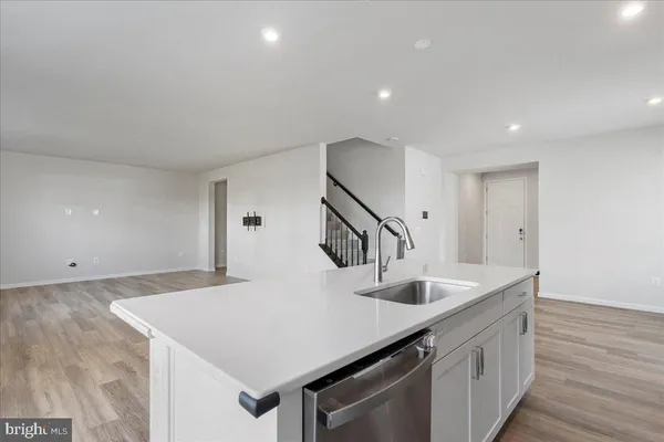 a kitchen with stainless steel appliances a refrigerator sink and cabinets