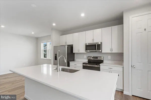 a kitchen with a refrigerator stove and microwave