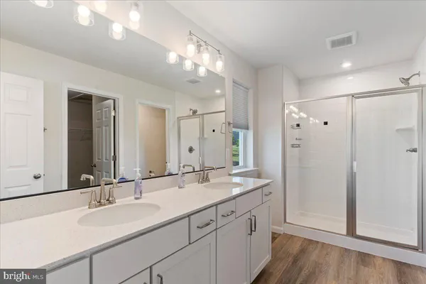 a bathroom with a sink double vanity and a mirror