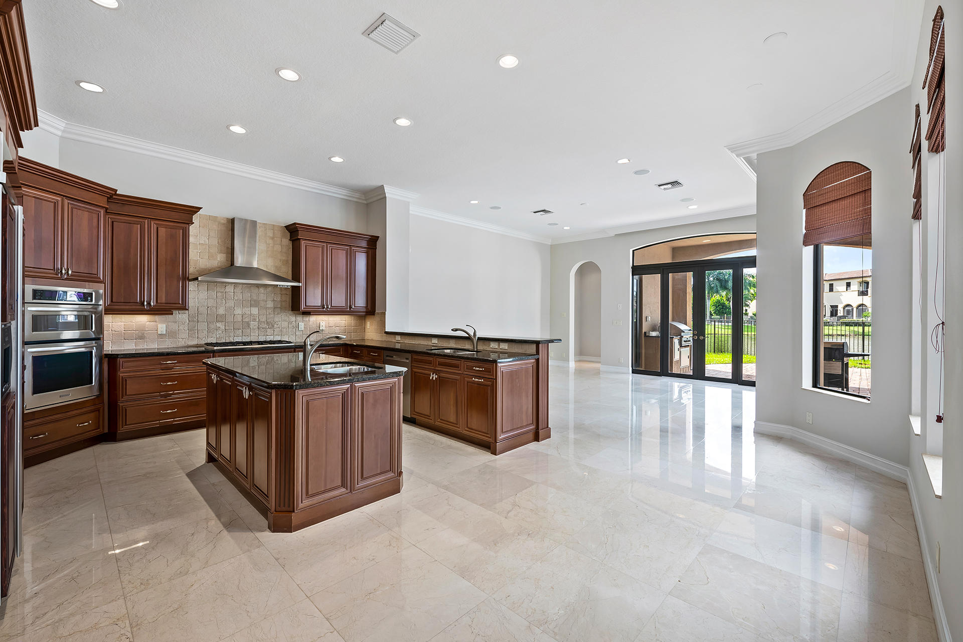17895 Cadena Drive Boca Raton, FL 33496 - Photo 13 of 64 a kitchen with stainless steel appliances granite countertop a stove top oven a sink a counter space and cabinets