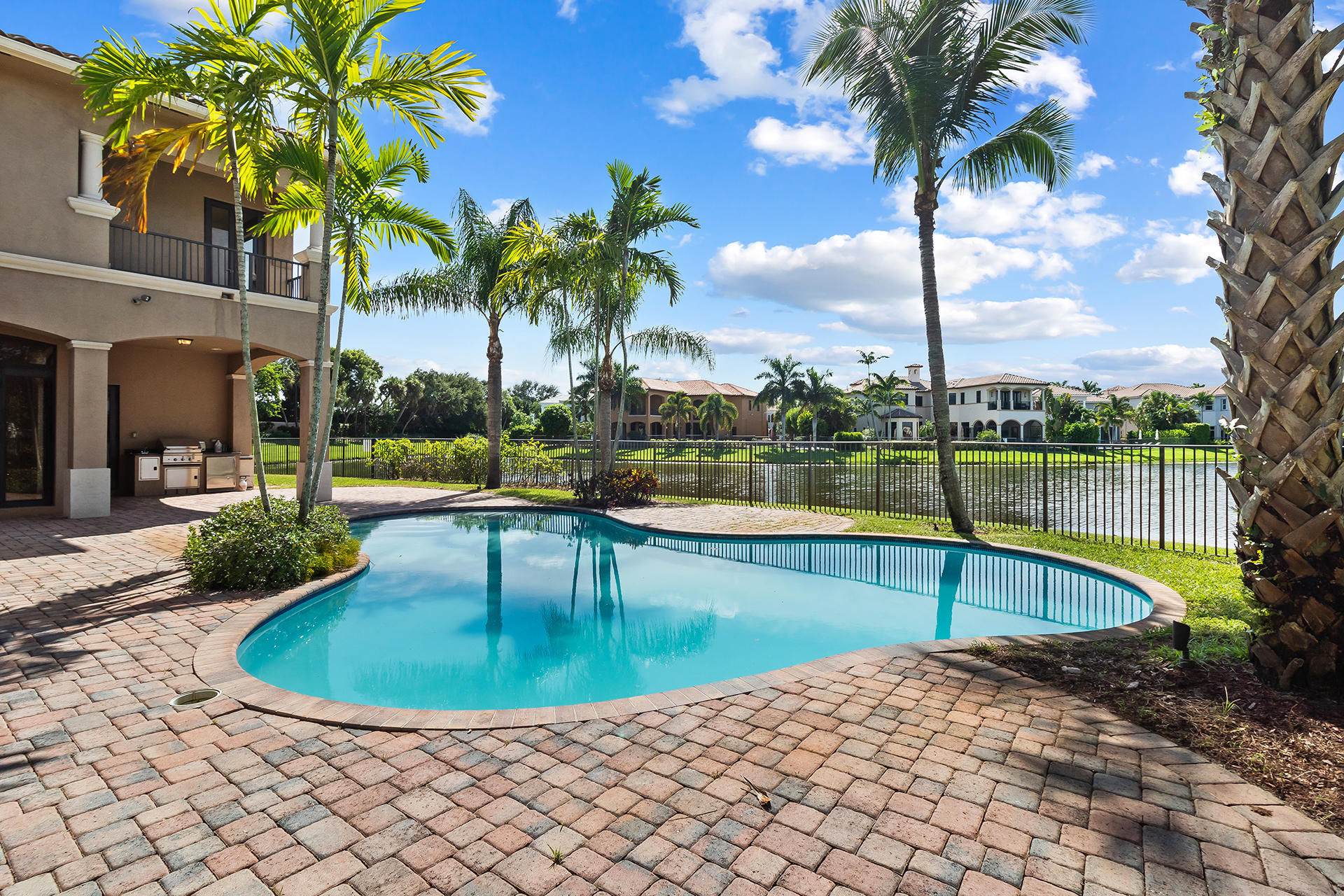 17895 Cadena Drive Boca Raton, FL 33496 - Photo 17 of 64 a view of a swimming pool with a lounge chair and palm trees