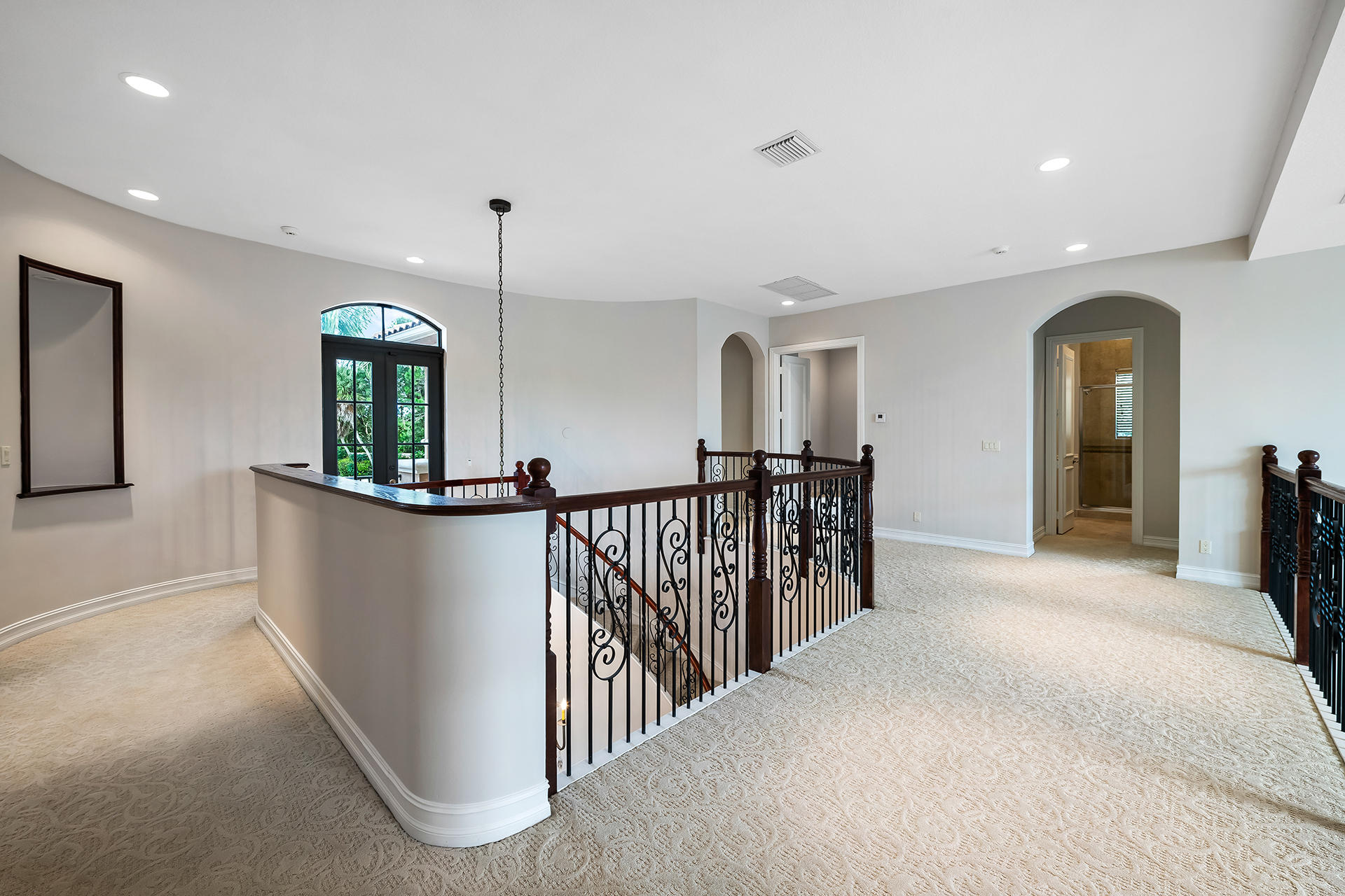 17895 Cadena Drive Boca Raton, FL 33496 - Photo 32 of 64 a view of a hallway with furniture and a flat screen tv