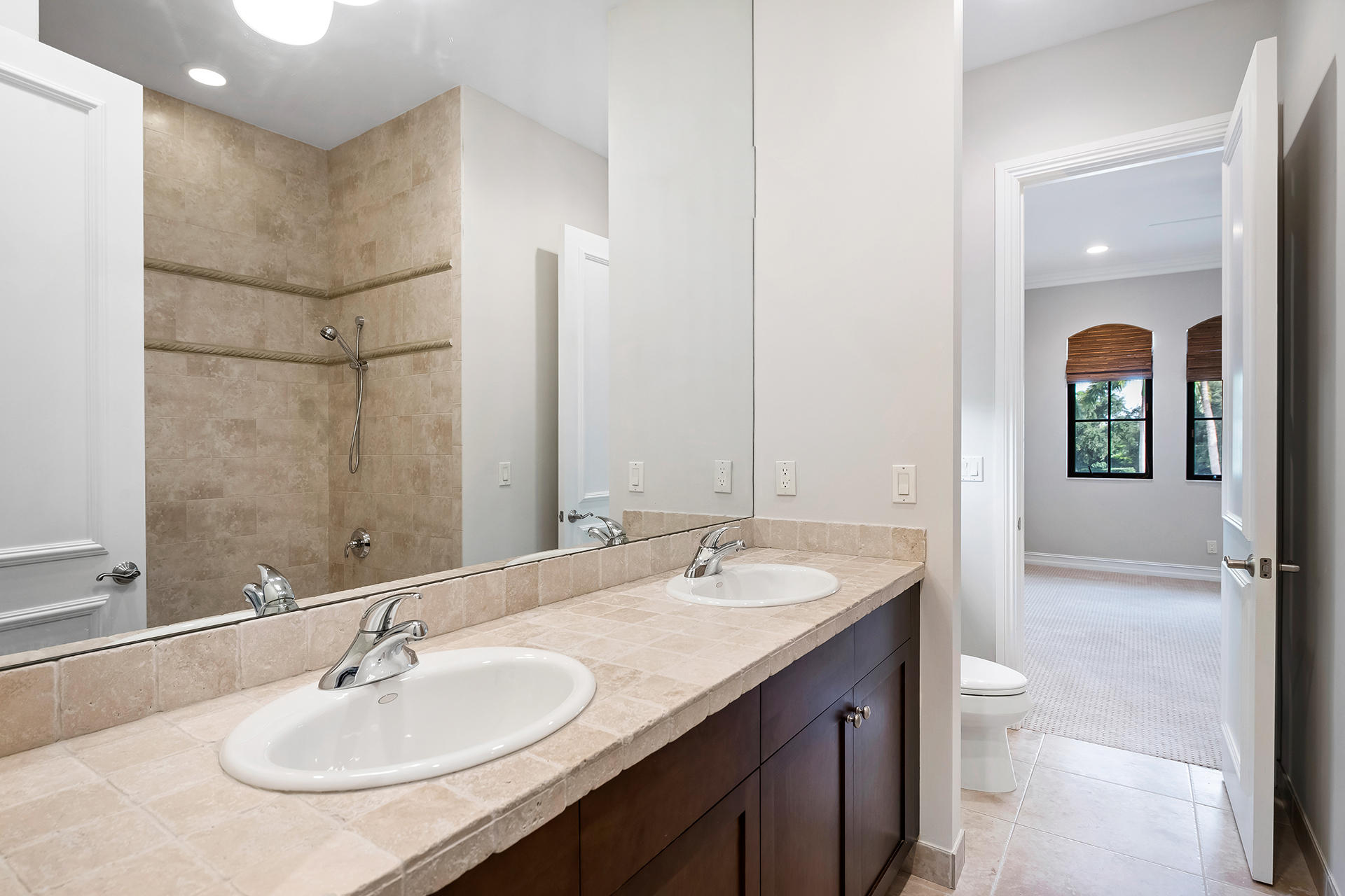 17895 Cadena Drive Boca Raton, FL 33496 - Photo 38 of 64 a bathroom with a granite countertop sink a toilet and a large mirror