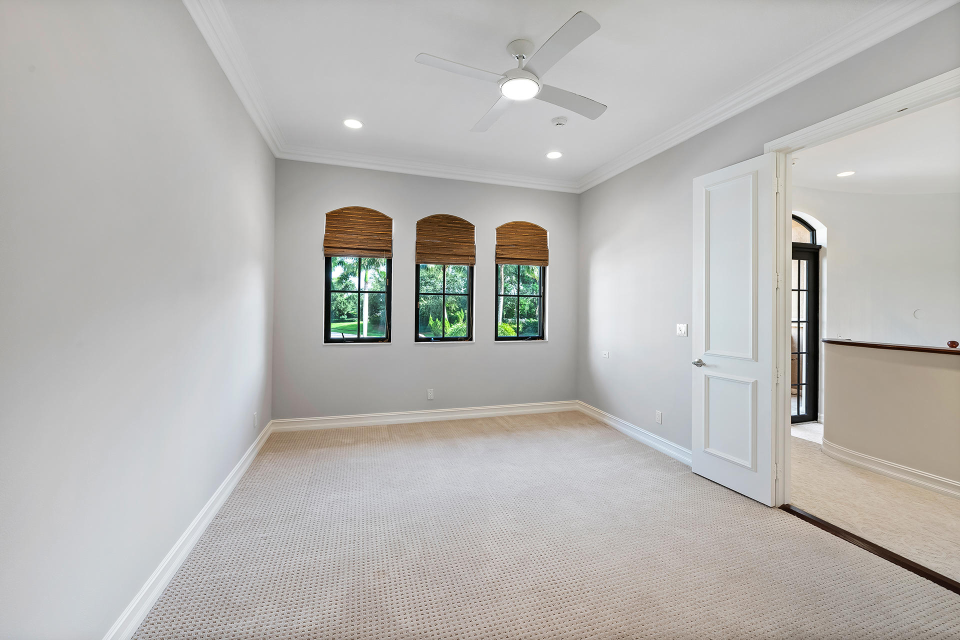 17895 Cadena Drive Boca Raton, FL 33496 - Photo 40 of 64 an empty room with windows and chandelier fan