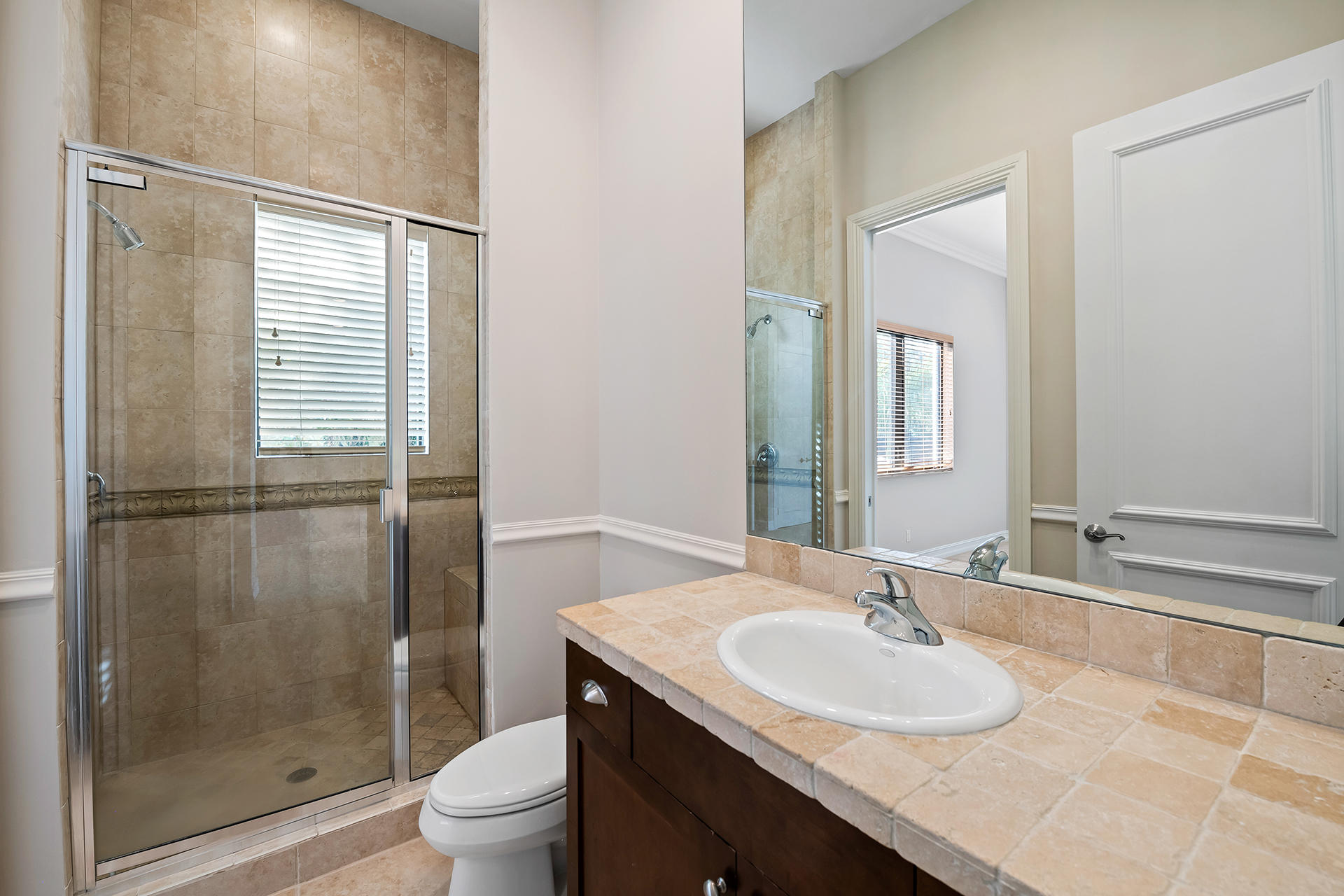 17895 Cadena Drive Boca Raton, FL 33496 - Photo 46 of 64 a bathroom with a granite countertop sink toilet a mirror and shower