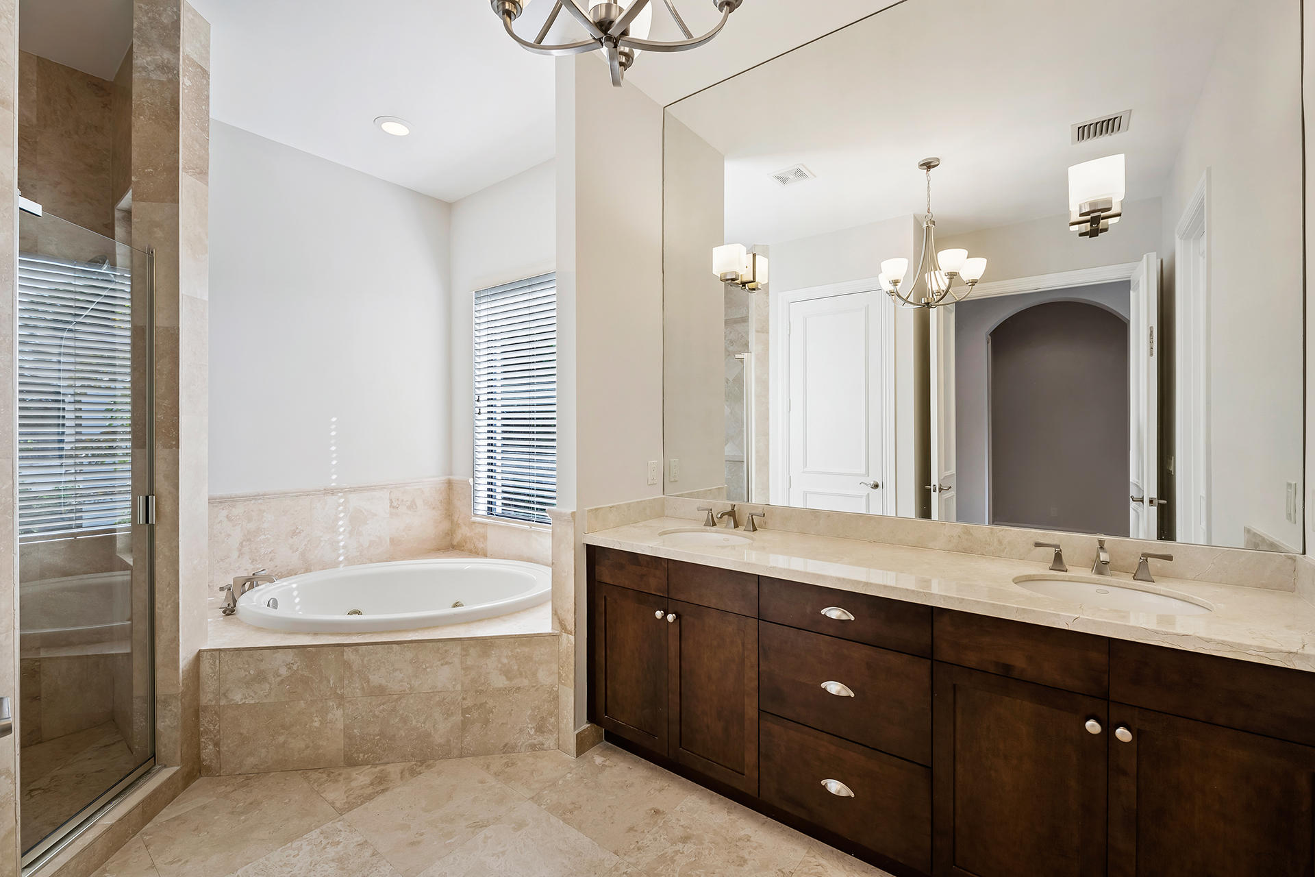 17895 Cadena Drive Boca Raton, FL 33496 - Photo 51 of 64 a bathroom with a tub a double vanity sink and mirror