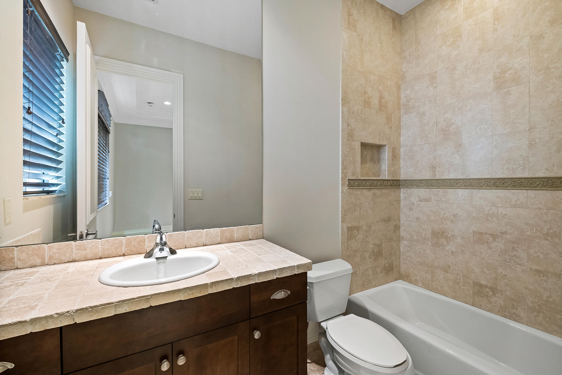 17895 Cadena Drive Boca Raton, FL 33496 - Photo 55 of 64 a bathroom with a granite countertop sink toilet a mirror and shower