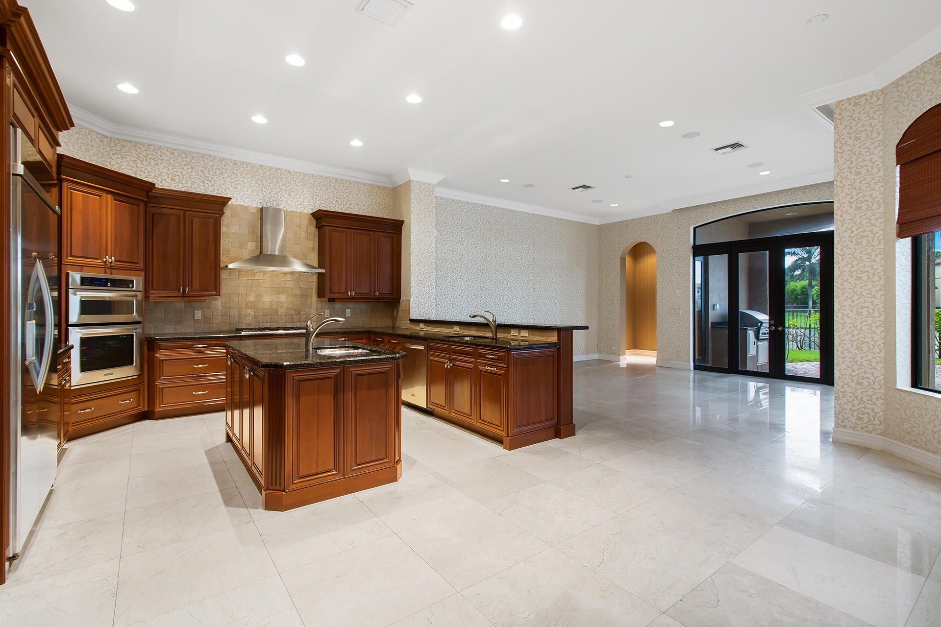 17895 Cadena Drive Boca Raton, FL 33496 - Photo 9 of 64 a kitchen with stainless steel appliances granite countertop a stove top oven a sink and a refrigerator