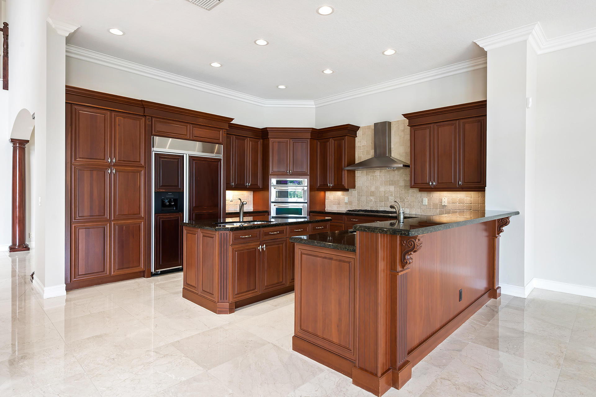 17895 Cadena Drive Boca Raton, FL 33496 - Photo 10 of 64 a kitchen with stainless steel appliances granite countertop wooden cabinets a refrigerator and a sink