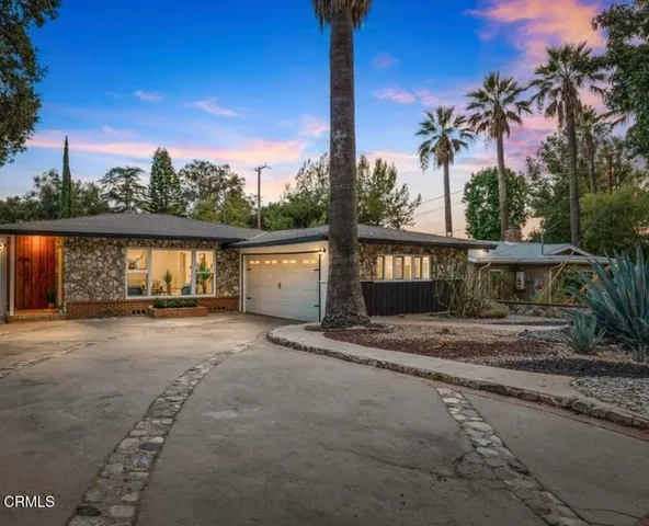 a view of a house with a yard and mountain view