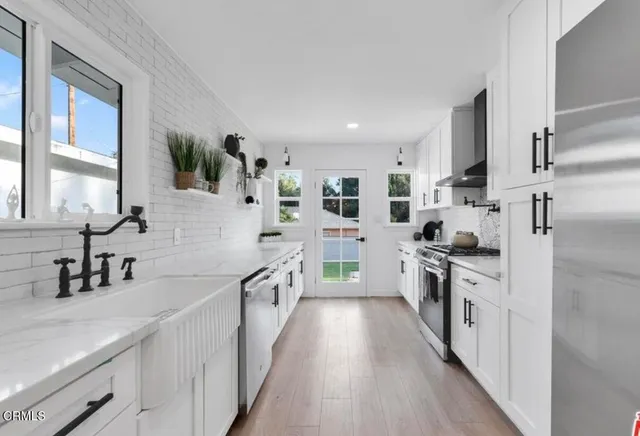 a kitchen with cabinets a sink and appliances
