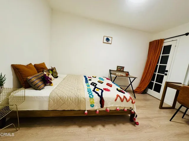 a bedroom with a bed and dresser