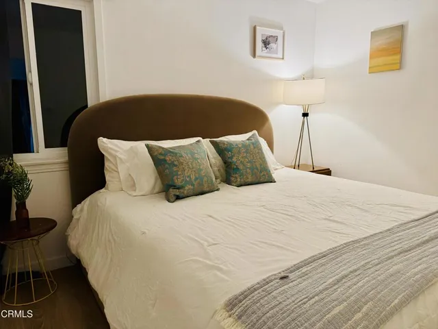 a bedroom with a bed and a table