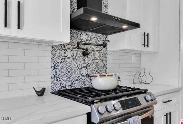 a stove top oven sitting inside of a kitchen