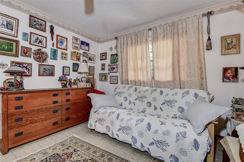 7323 Ray Browning Road Brooksville, FL 34601 - Photo 13 of 46 a bed room with a bed and a dresser