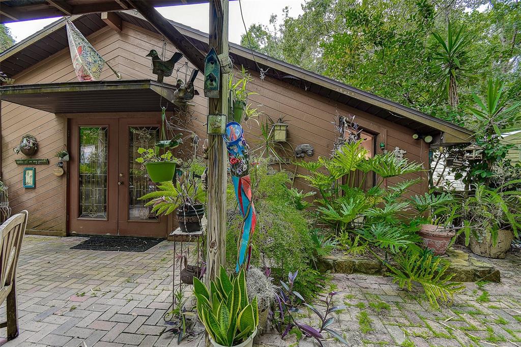 7323 Ray Browning Road Brooksville, FL 34601 - Photo 23 of 46 a backyard of a house with potted plants