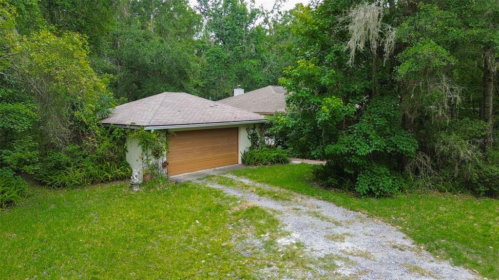 7323 Ray Browning Road Brooksville, FL 34601 - Photo 28 of 46 a aerial view of a house with table and chairs under an umbrella