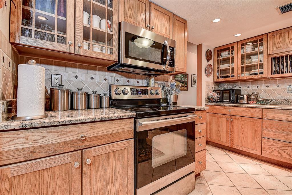 7323 Ray Browning Road Brooksville, FL 34601 - Photo 4 of 46 a kitchen with stainless steel appliances granite countertop a stove and a sink
