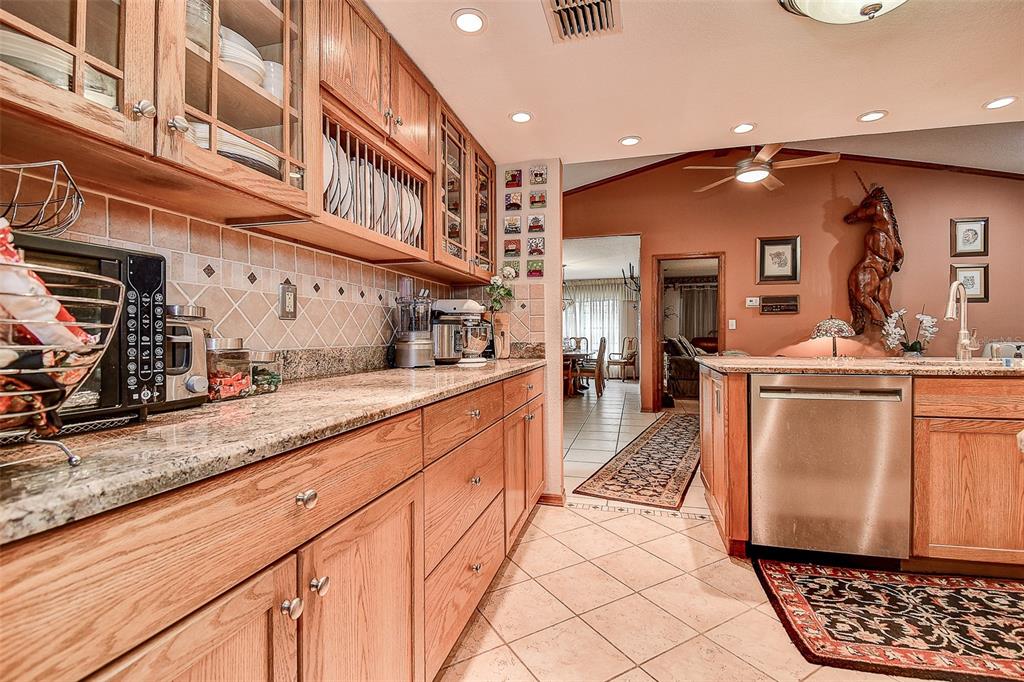 7323 Ray Browning Road Brooksville, FL 34601 - Photo 5 of 46 a kitchen with stainless steel appliances granite countertop a sink and cabinets