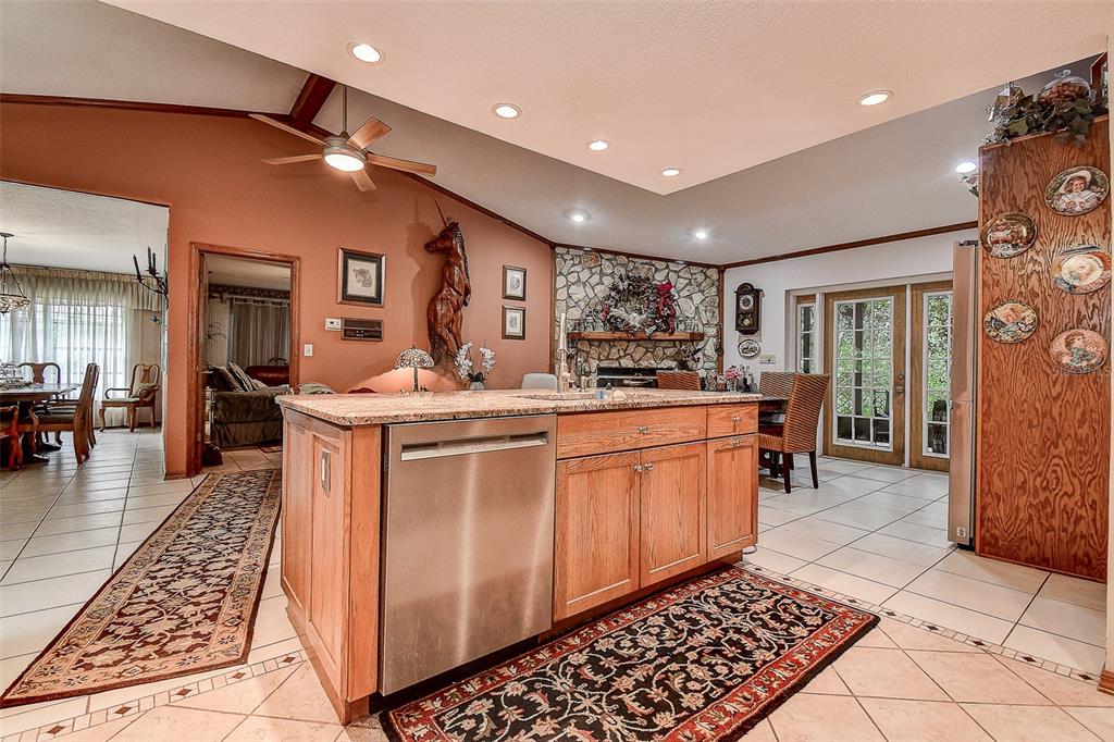 7323 Ray Browning Road Brooksville, FL 34601 - Photo 6 of 46 a kitchen with stainless steel appliances granite countertop a sink and cabinets
