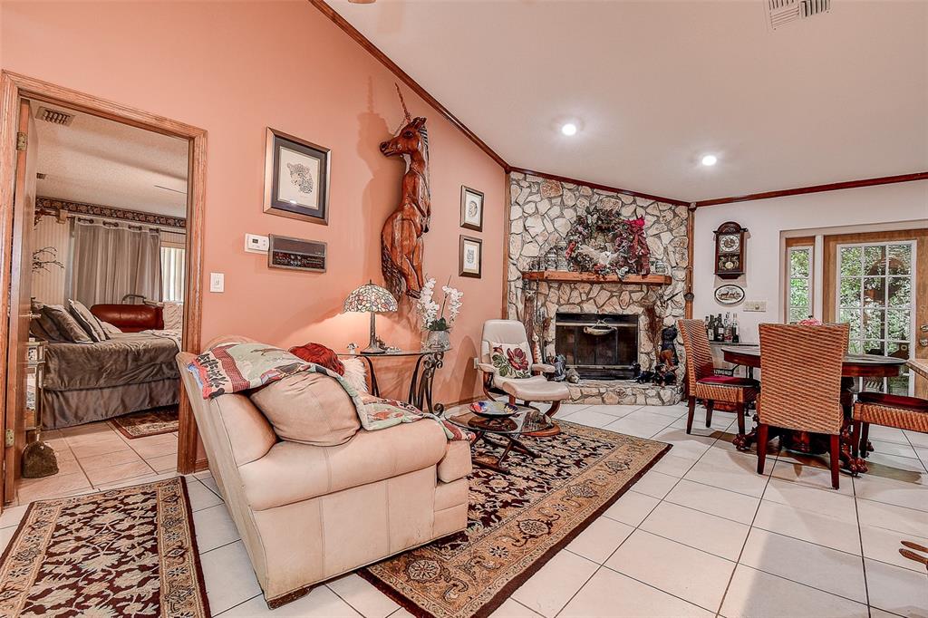 7323 Ray Browning Road Brooksville, FL 34601 - Photo 7 of 46 a living room with furniture and a fireplace