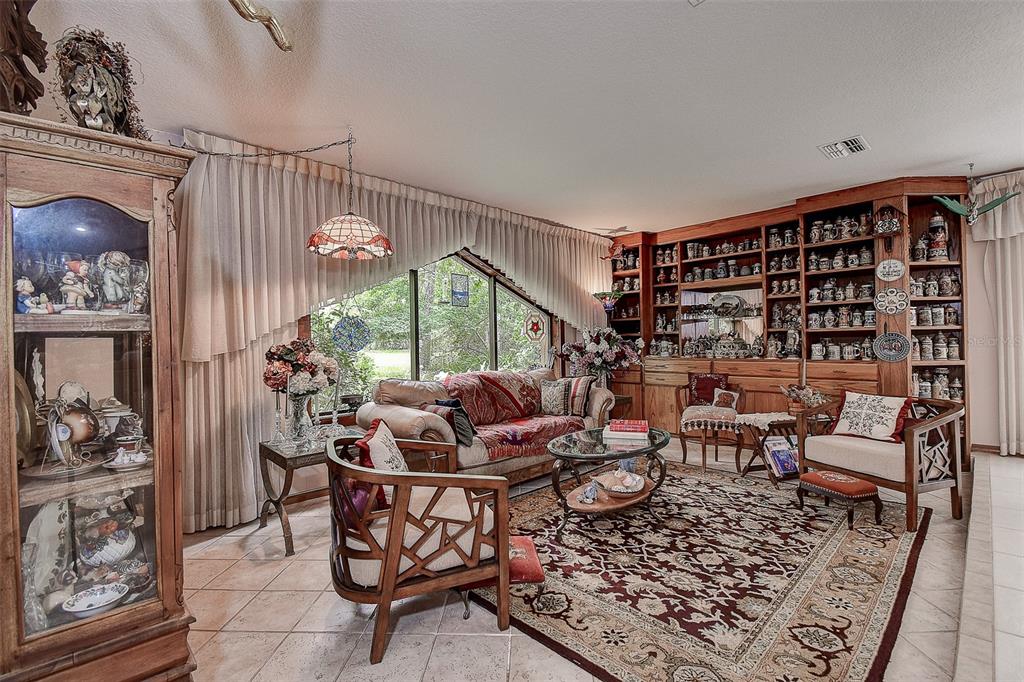 7323 Ray Browning Road Brooksville, FL 34601 - Photo 9 of 46 a living room with furniture and a fireplace