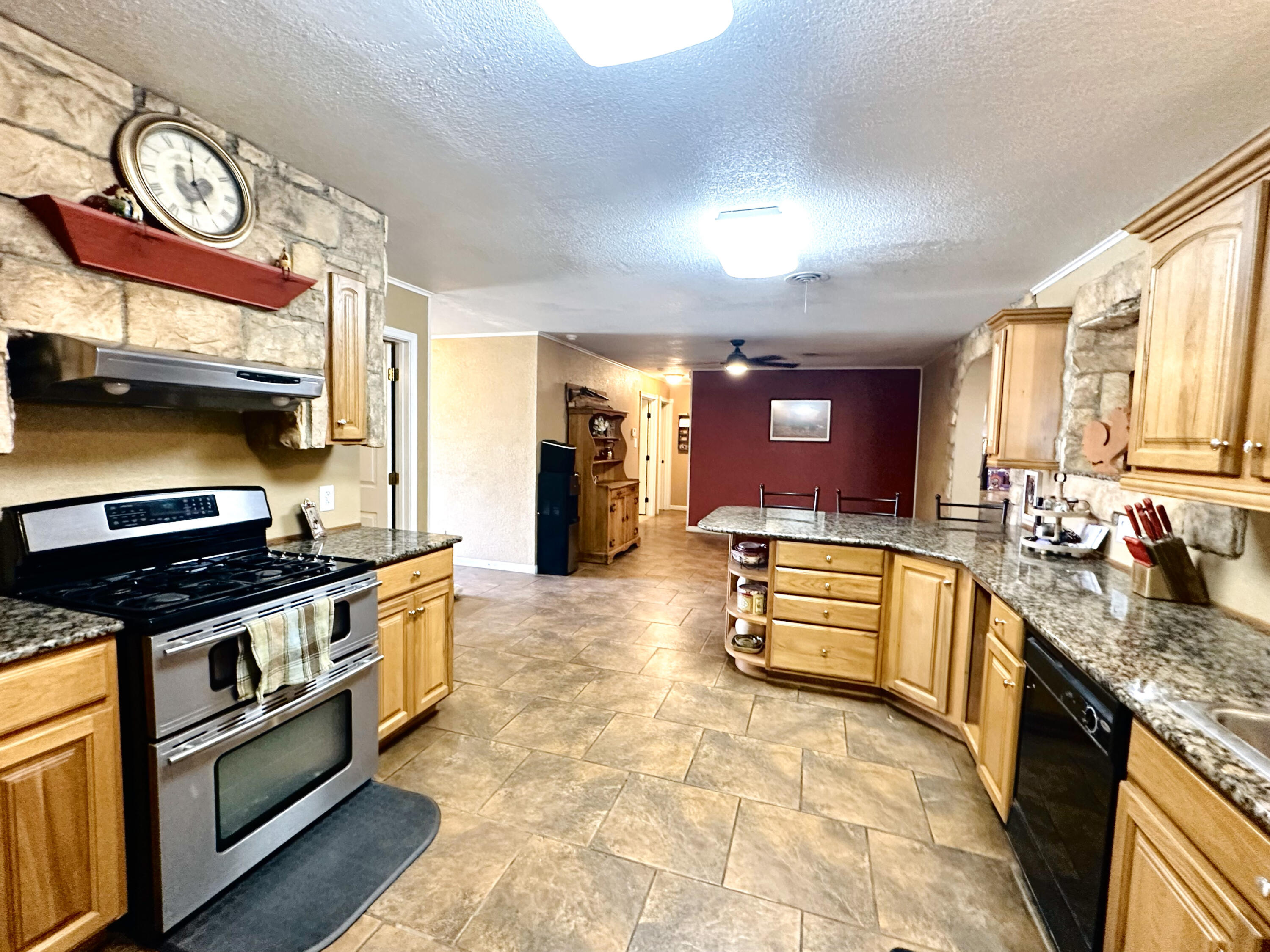 403 Osage Avenue Post, TX 79356 - Photo 12 of 31 a large kitchen with stainless steel appliances granite countertop a stove and a sink