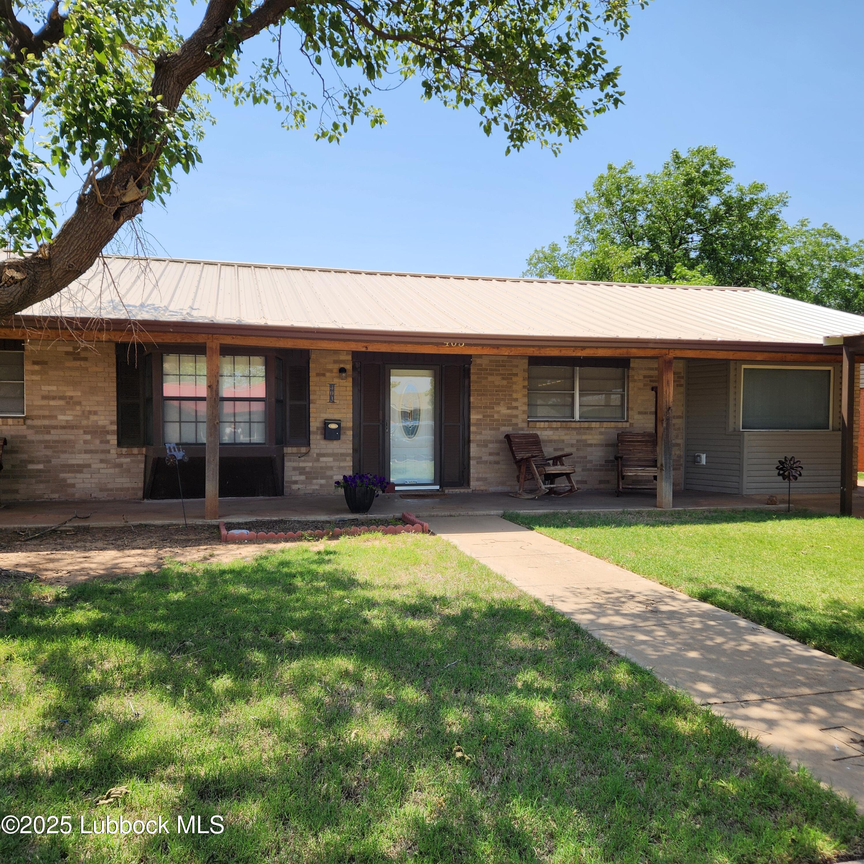 403 Osage Avenue Post, TX 79356 - Photo 2 of 31 a front view of a house with a yard and garage
