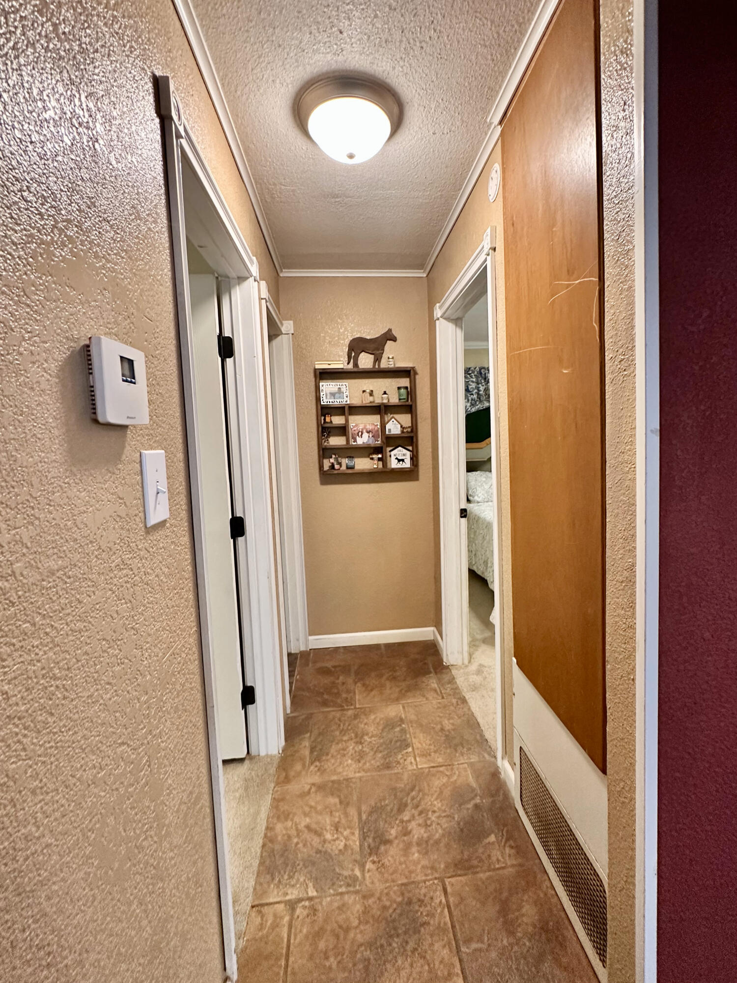 403 Osage Avenue Post, TX 79356 - Photo 22 of 31 a view of a hallway with wooden shelves