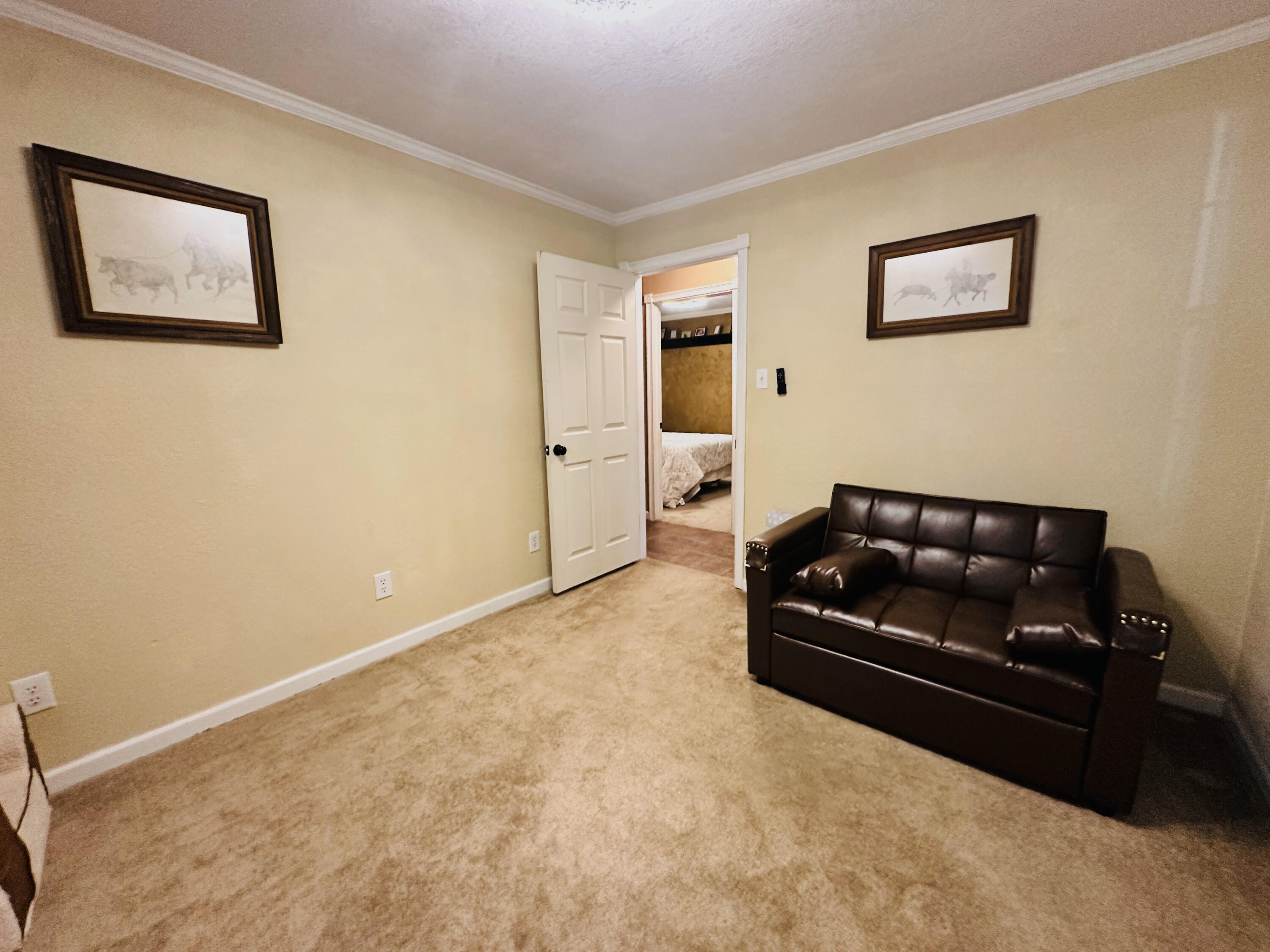 403 Osage Avenue Post, TX 79356 - Photo 24 of 31 a living room with furniture and wall paintings