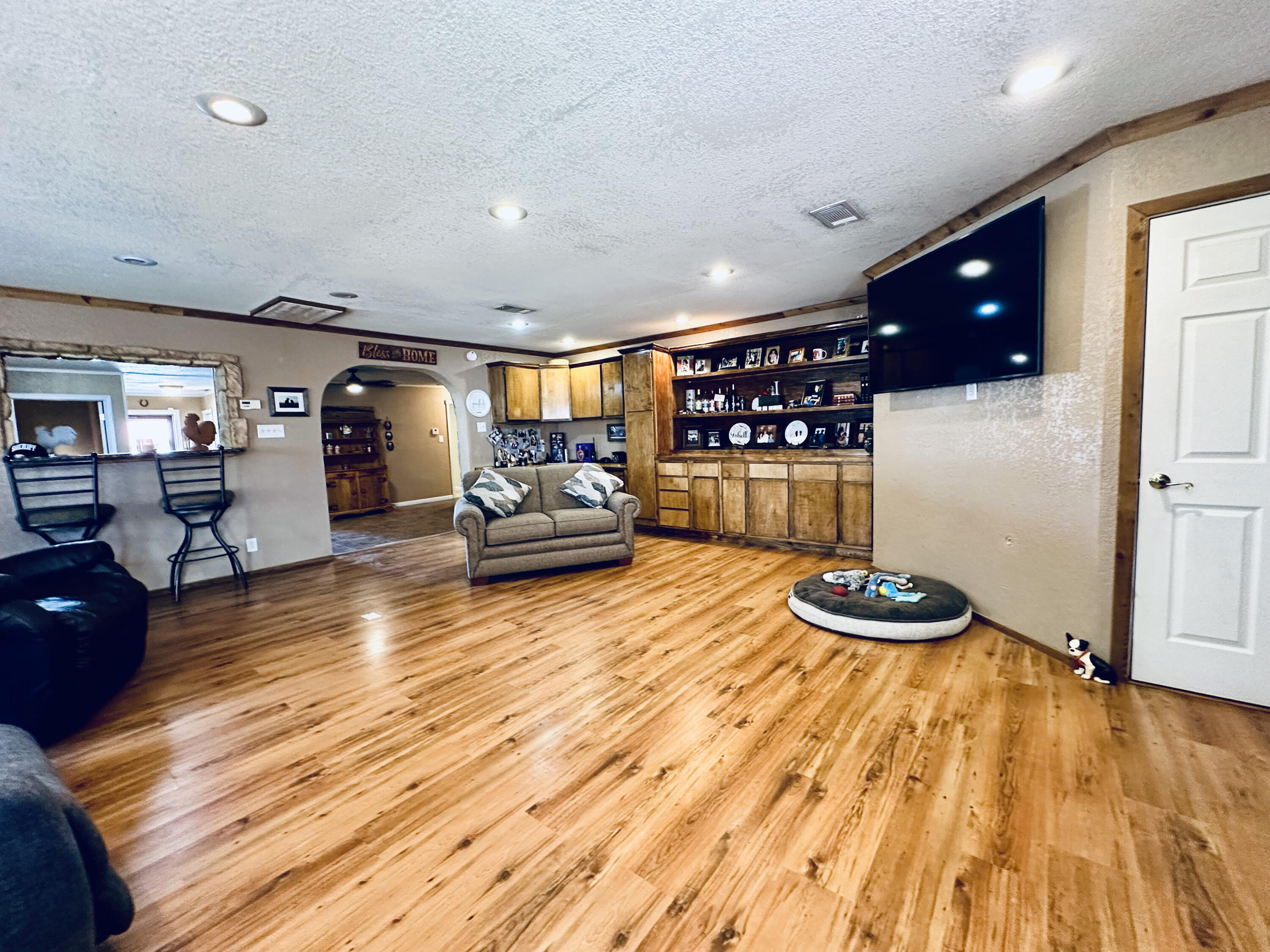 403 Osage Avenue Post, TX 79356 - Photo 8 of 31 a room with wooden floors and furniture