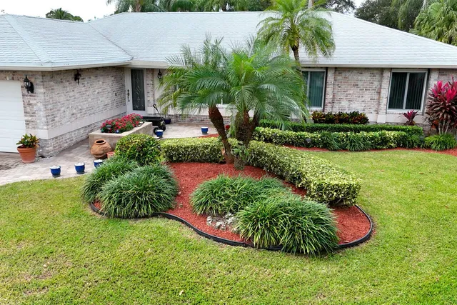 a front view of a house with garden