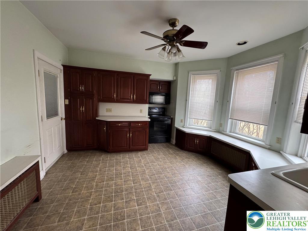1352 Main Street Hellertown, PA 18055 - Photo 2 of 9 a living room with stainless steel appliances kitchen island granite countertop a sink a stove and a refrigerator