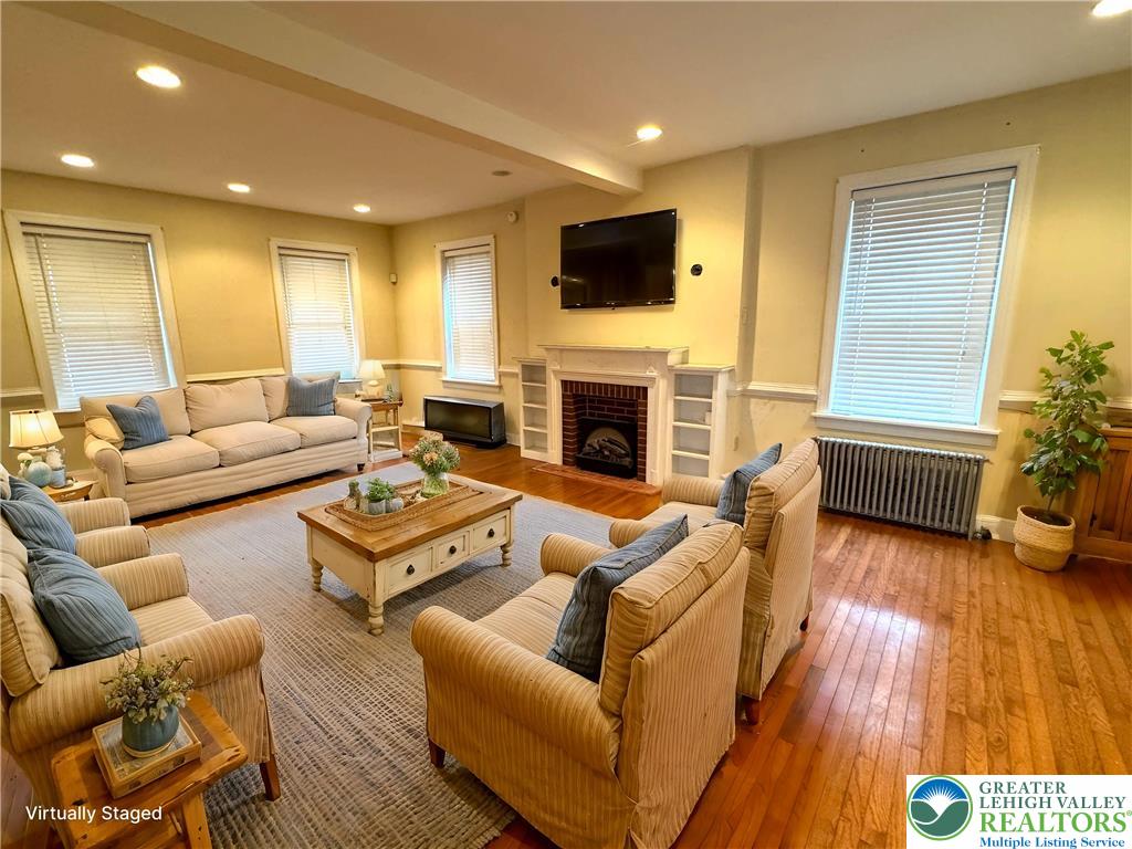1352 Main Street Hellertown, PA 18055 - Photo 3 of 9 a living room with furniture fireplace and a wooden floor