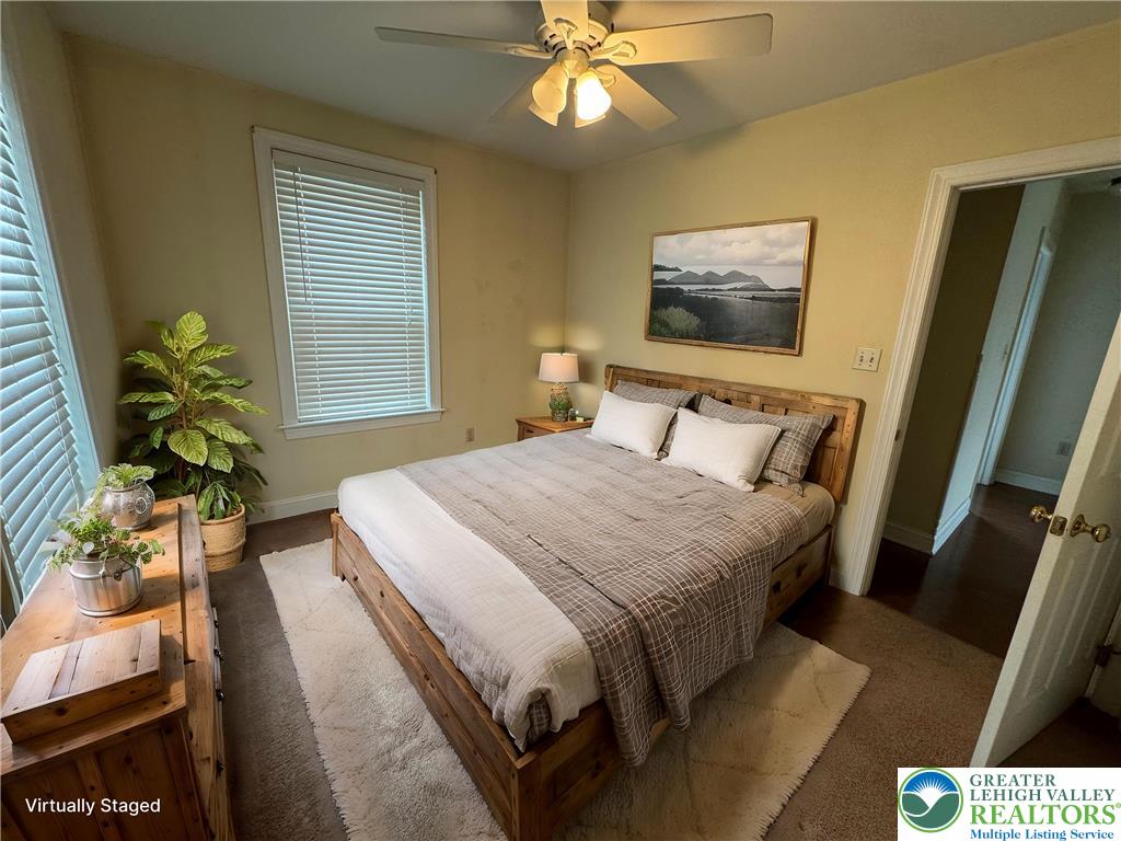 1352 Main Street Hellertown, PA 18055 - Photo 6 of 9 a bedroom with a bed and a chandelier