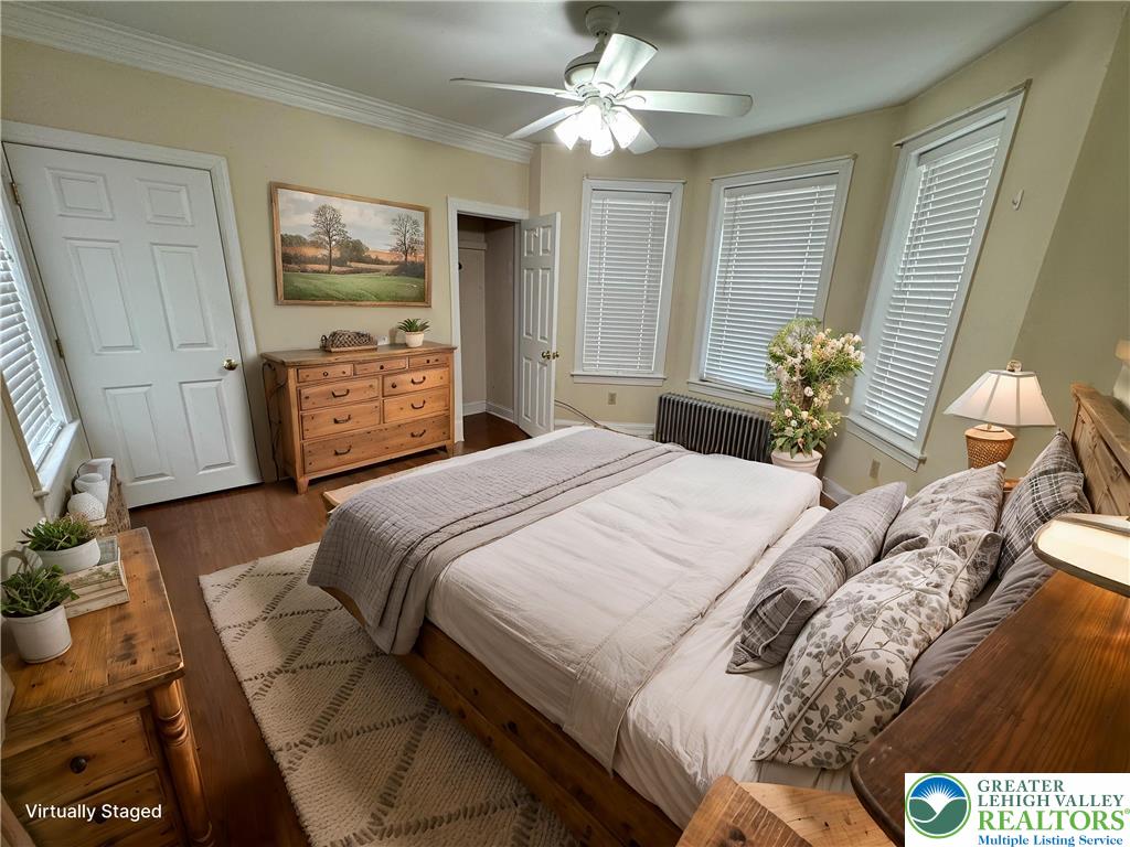 1352 Main Street Hellertown, PA 18055 - Photo 7 of 9 a bedroom with a bed and a chandelier