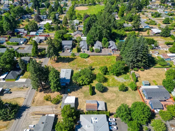 an aerial view of a houses with yard