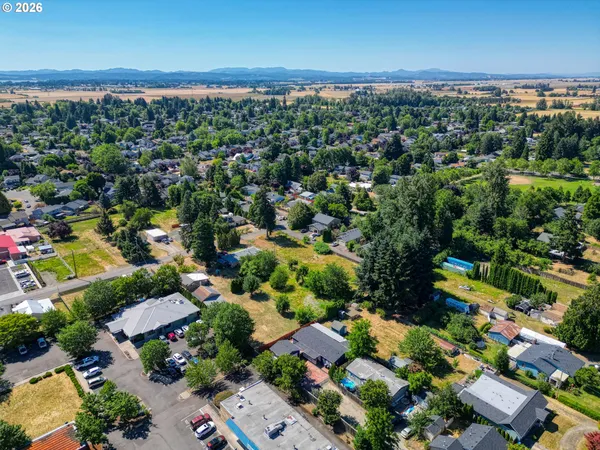 an aerial view of a houses with a yard