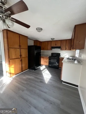 a kitchen with a refrigerator and a stove