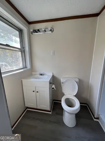 a white toilet sitting next to a bathroom sink